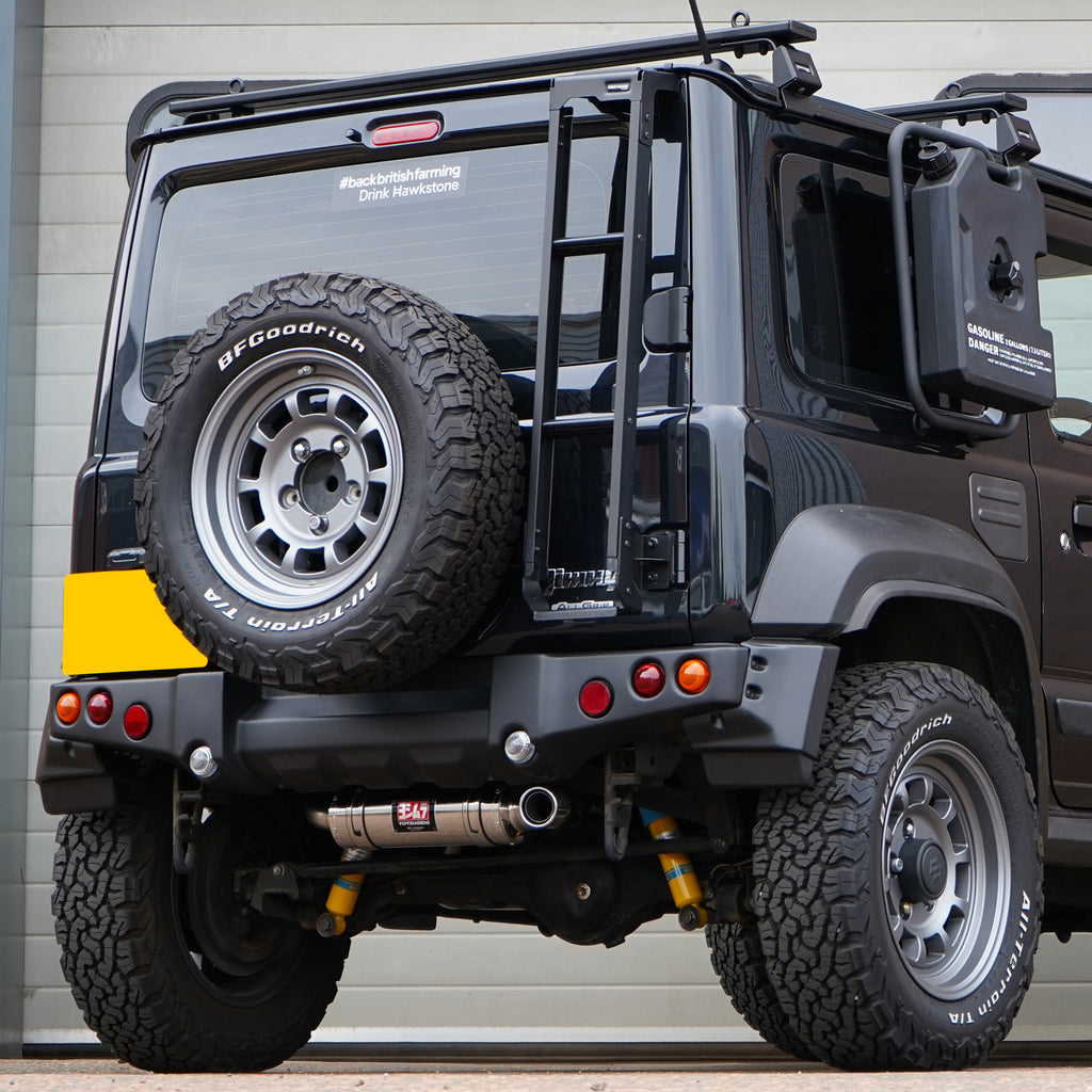 Photo of a Suzuki Jimny with a painted APIO Tactical Rear Bumper for Suzuki Jimny JB74 (2018+) fitted with a Jimy exhaust upgrade. Jimny Body kit modification. 